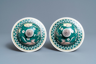 A pair of Chinese famille verte 'mythical animals' vases and covers, 19th C.