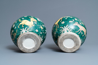 A pair of Chinese famille verte 'mythical animals' vases and covers, 19th C.