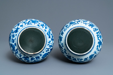A pair of Chinese blue and white 'peony scroll' vases and covers, Kangxi
