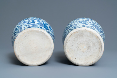 A pair of Chinese blue and white 'peony scroll' vases and covers, Kangxi