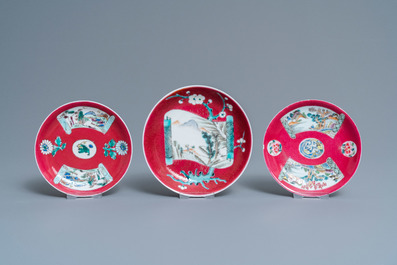 Three Chinese famille rose ruby-ground cups and saucers, Yongzheng