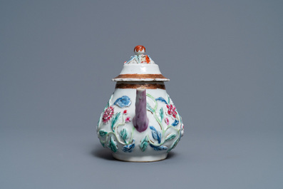 A Chinese famille rose relief-decorated teapot on stand, Yongzheng