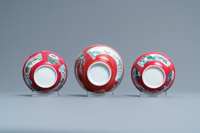 Three Chinese famille rose ruby-ground cups and saucers, Yongzheng