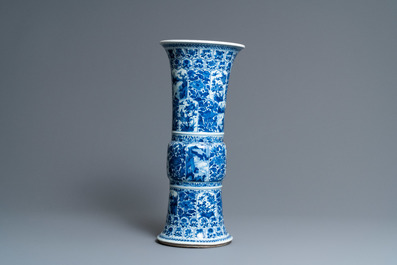 Een Chinese blauw-witte 'gu' vaas met florale en landschapspanelen, Kangxi