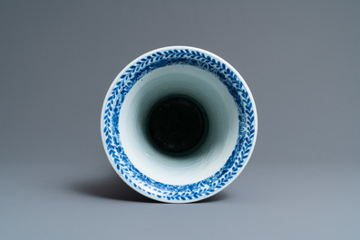 Een Chinese blauw-witte 'gu' vaas met florale en landschapspanelen, Kangxi