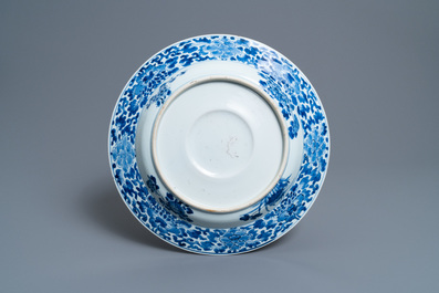 A Chinese blue and white dish with raised central medallion, Kangxi