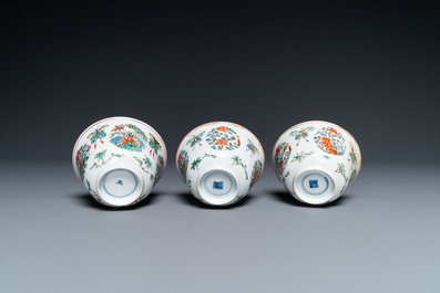 Eight Chinese famille rose plates and three famille verte cups, Kangxi/Qianlong