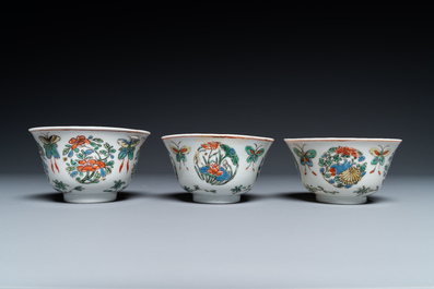 Eight Chinese famille rose plates and three famille verte cups, Kangxi/Qianlong