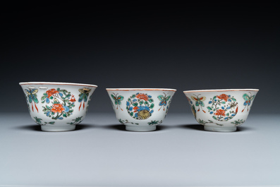 Eight Chinese famille rose plates and three famille verte cups, Kangxi/Qianlong