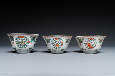 Eight Chinese famille rose plates and three famille verte cups, Kangxi/Qianlong