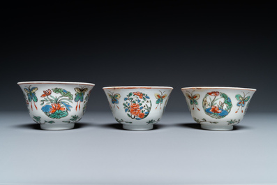 Eight Chinese famille rose plates and three famille verte cups, Kangxi/Qianlong