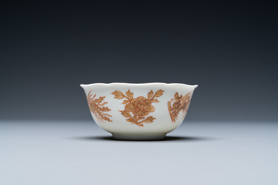 A Chinese iron-red and gilt 'phoenixes' cup and saucer, Kangxi