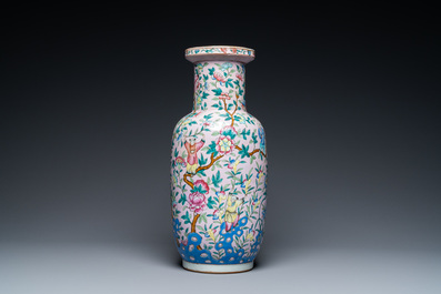 A Chinese pink-ground famille rose rouleau vase, 19th C.