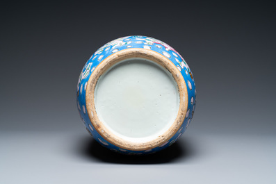 A Chinese pink-ground famille rose rouleau vase, 19th C.