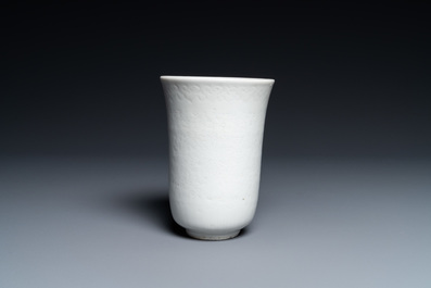 A Chinese white-glazed anhua-decorated 'peony' cup, Xuande mark, Kangxi