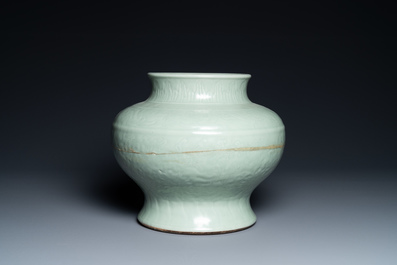 A Chinese monochrome celadon vase with underglaze floral design, Chenghua mark, Kangxi