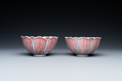 A pair of Chinese blue, white and copper-red 'lotus' bowls, Kangxi mark, 19th C.