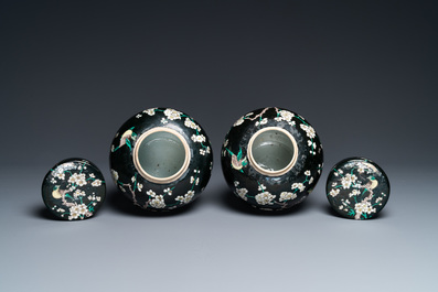 A pair of Chinese famille noire jars and covers, 19th C.