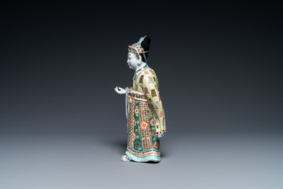 A Chinese famille verte figure on wooden stand, Kangxi
