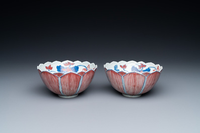 A pair of Chinese blue, white and copper-red 'lotus' bowls, Kangxi mark, 19th C.