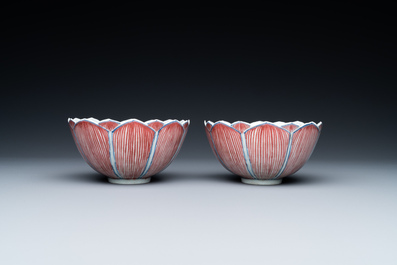 A pair of Chinese blue, white and copper-red 'lotus' bowls, Kangxi mark, 19th C.