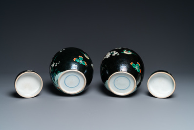 A pair of Chinese famille noire jars and covers, 19th C.