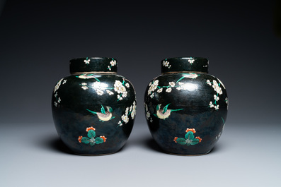 A pair of Chinese famille noire jars and covers, 19th C.