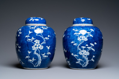 A pair of large Chinese blue and white 'prunus' jars and covers, 19th C.