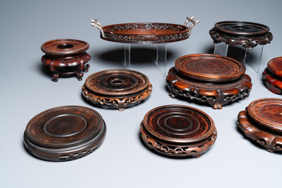 A varied collection of Chinese wooden stands and a silver-mounted tray, 19/20th C.