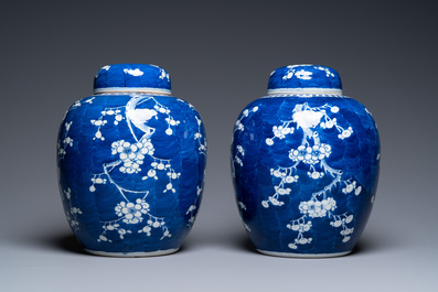 A pair of large Chinese blue and white 'prunus' jars and covers, 19th C.