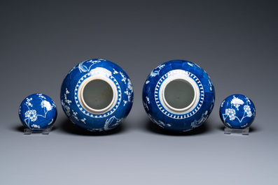 A pair of large Chinese blue and white 'prunus' jars and covers, 19th C.