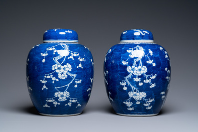 A pair of large Chinese blue and white 'prunus' jars and covers, 19th C.