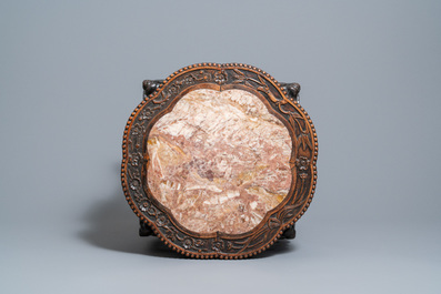 A Chinese carved wooden marble top stand, 19th C.