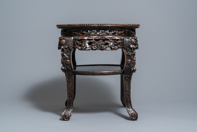 A Chinese carved wooden marble top stand, 19th C.