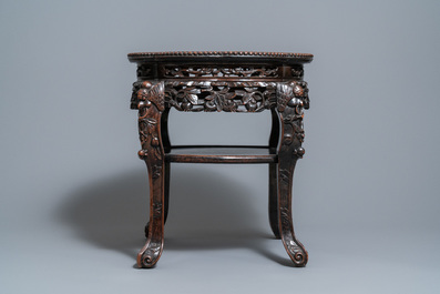 A Chinese carved wooden marble top stand, 19th C.