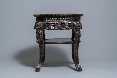 A Chinese carved wooden marble top stand, 19th C.