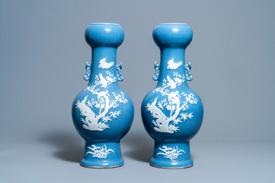 A pair of Chinese white slip-decorated blue-ground vases, 19th C.