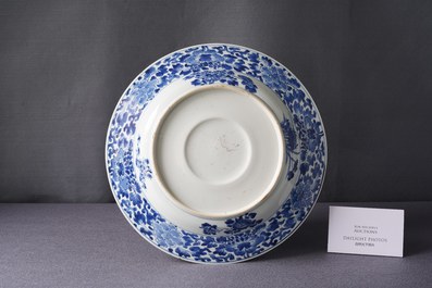 A Chinese blue and white dish with raised central medallion, Kangxi