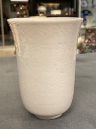 A Chinese white-glazed anhua-decorated 'peony' cup, Xuande mark, Kangxi