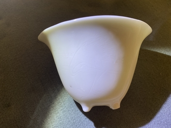 A Chinese Dehua blanc de Chine tripod wine cup with inscription, Kangxi