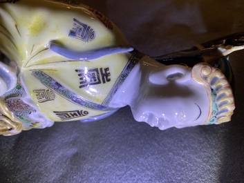 A Chinese famille verte figure on wooden stand, Kangxi