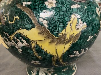 A pair of Chinese famille verte 'mythical animals' vases and covers, 19th C.