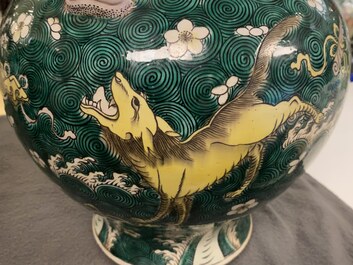 A pair of Chinese famille verte 'mythical animals' vases and covers, 19th C.