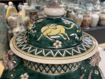 A pair of Chinese famille verte 'mythical animals' vases and covers, 19th C.