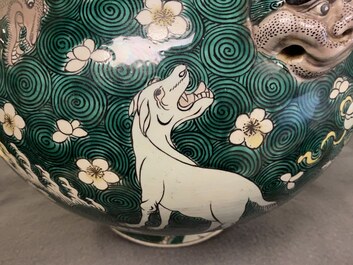 A pair of Chinese famille verte 'mythical animals' vases and covers, 19th C.
