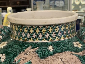 A pair of Chinese famille verte 'mythical animals' vases and covers, 19th C.