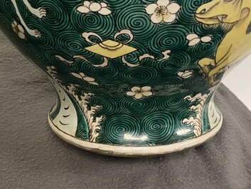 A pair of Chinese famille verte 'mythical animals' vases and covers, 19th C.