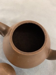 Four Chinese Yixing stoneware, blue and white and monochrome black porcelain teapots, Kangxi and later
