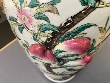 A Chinese famille rose molded 'nine peaches' vase, 19th C.