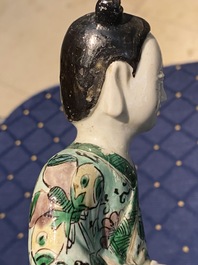 A Chinese verte biscuit figure, a green 'lotus' jar and a figurative blue and white plate, Kangxi and later